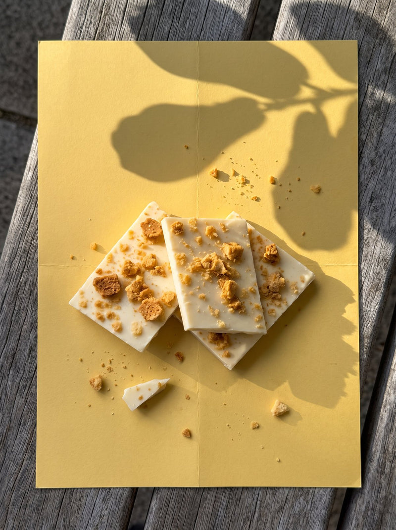 White Mylk Honeycomb Crunch slabs on yellow paper