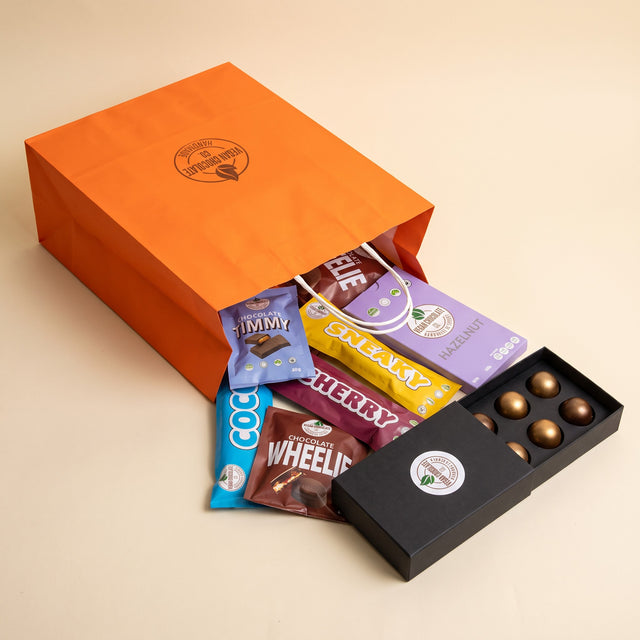 Gift Bag - Two of the Classics: the chocolates spilling out of the orange Vegan Chocolate Co gift bag